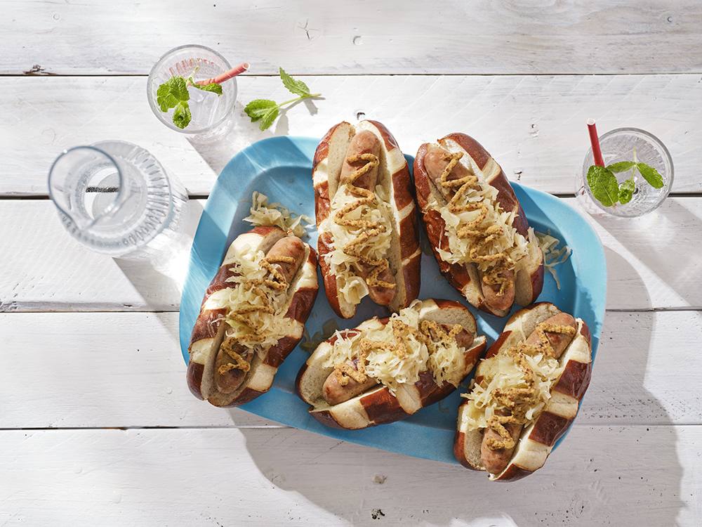 Beer-Braised Sausages with Sauerkraut on Pretzel Buns | Savory